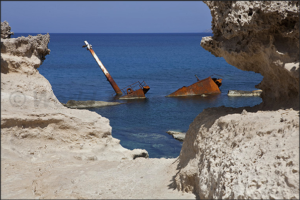 Rocky beaches of Sarakinikos. Wreck of a small merchant