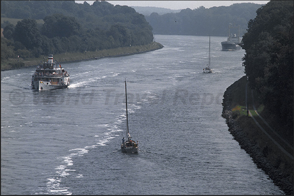 In navigation in Kiel Canal. Merchant ships, wheel steamers and sailing boats