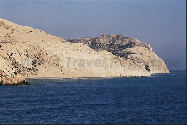 The wild rocky coast of the eastern part of Petra Tou Romiou Bay
