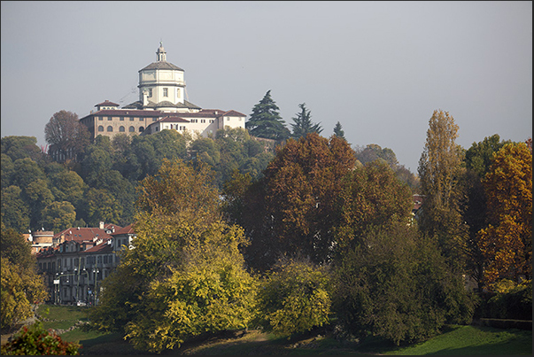 Monte dei Cappuccini in the colors of autumn rises above the Po river
