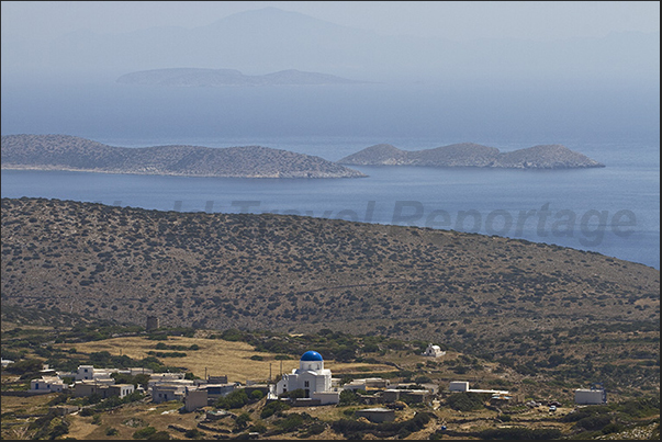 Panagia church of Pano Horio. In front of the islands of Aghrilou and Kato Antikeri. On the horizon Amorgos island