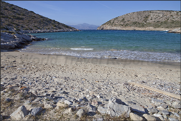 Beach at the bottom of the bay of Vourkaria and the island of Naxos which closes the bay
