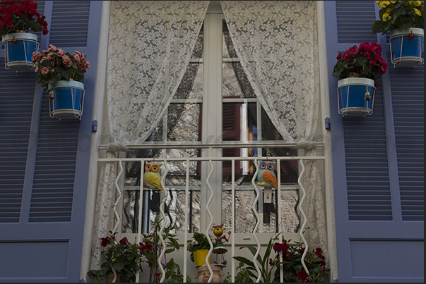 Vases of flowers decorate the windows in the streets of the village