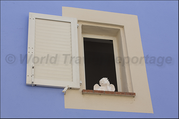 Decorations at the windows of Rue Frédéric Mistral, the last street south of the village