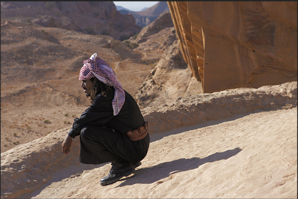 A Berber guide looks at the view from the roof of the temple of Al-Deir