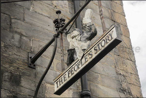 Often, on ancient buildings, one can notice old clocks and signs of businesses that have now disappeared