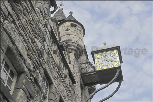 Often, on ancient buildings, one can notice old clocks and signs of businesses that have now disappeared