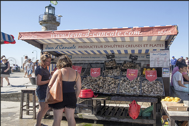 At the port of Cancale, oyster farmers sell freshly harvested oysters directly to tourists
