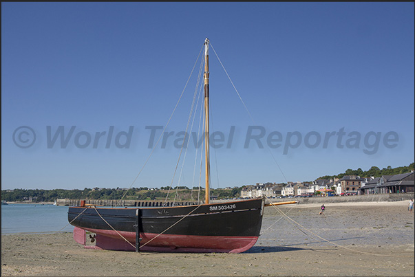Cancale Bay. A Breton boat balanced on its keel in the harbor at low tide