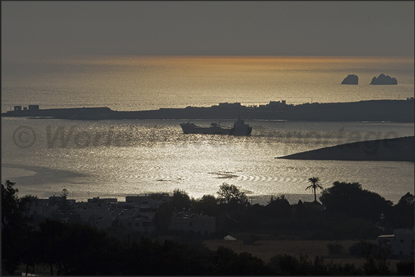 A vessel carrying drinking water leaves the island of Paros
