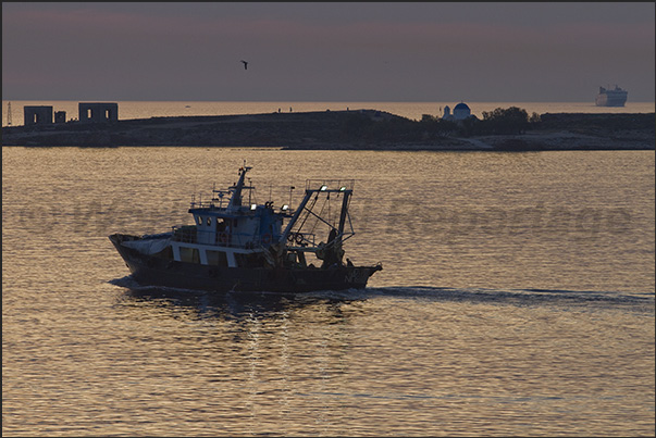 At sunset the fishing boats leave for the fishing grounds where they will spend the night.