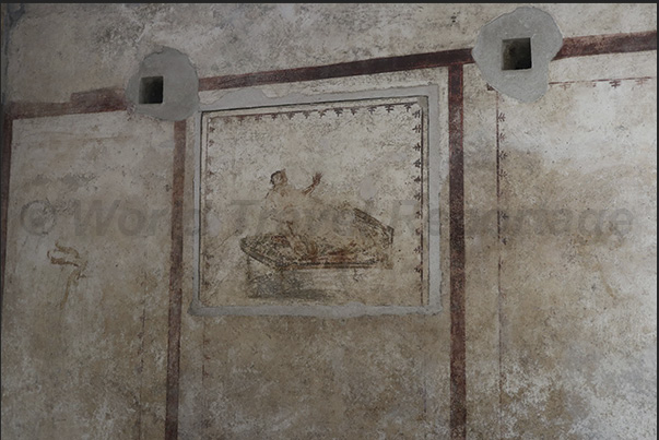 Refined paintings decorate the walls of the triclinium room.