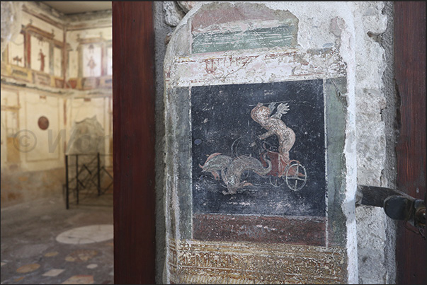 Fresco depicting a cupid (putto) driving a chariot pulled by two dolphins