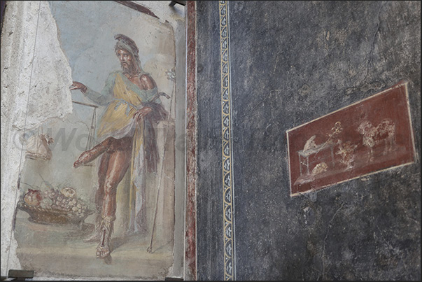 Vestibule of Villa Vetii, Priapus (Greek-Roman god of fertility) places his member on the scales as a symbol of prosperity
