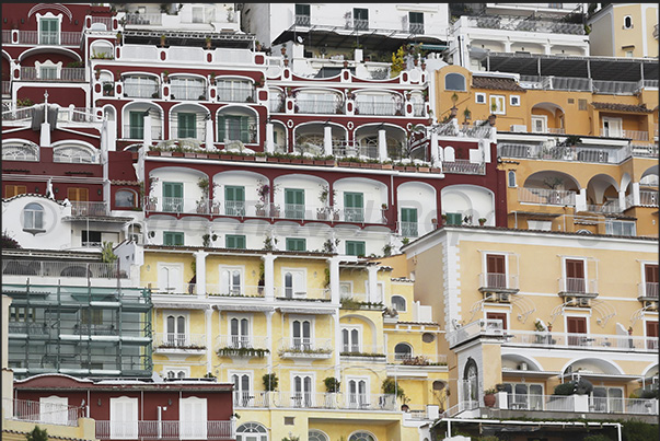 The colorful houses of the village of Positano are clustered together on the rocky cliff