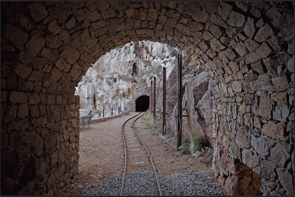 The rail route within the mine in the village of Buggerru. Mines which penetrate the rocky cliff overlooking the sea
