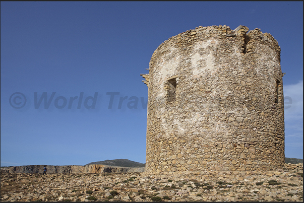 The ancient Spanish watchtower (eighteenth century) at the entrance to Cala Domestica Bay