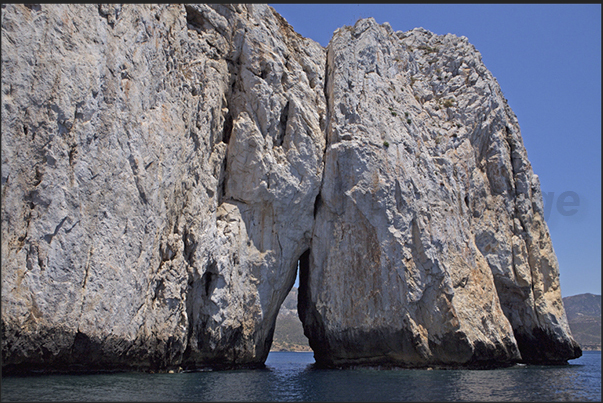 One of the two large cracks in the rock of the island called Pan di Zucchero (Sugarloaf), in the Masua bay, in front of Porto Flavia