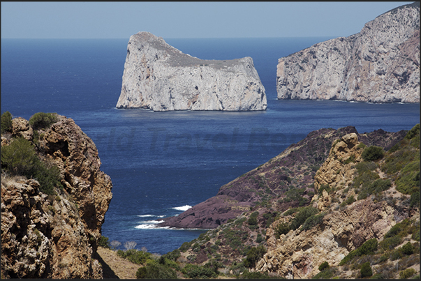 The cliffs below the village of Nebida between Masua Bay and Portoscuso. On the horizon (left), the Pan di Zucchero island