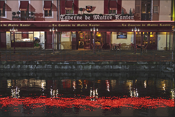 The Christmas lights are reflected on the waters of the canal