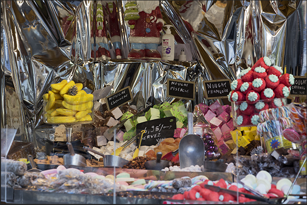 A stand with candied fruit, candy and sweets