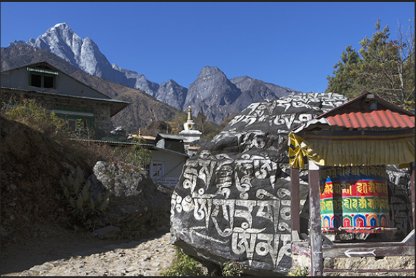 Village of Ghat-Nurning (2592 m). Stones and cylinder prayer before a Stupa (sacred monument)
