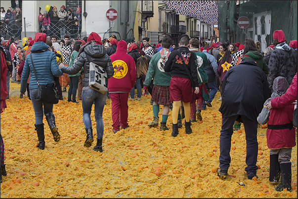 In the evening, streets and squares are covered by a layer of oranges destined to be destroyed and not eatable