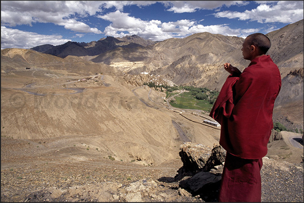A Buddhist monk directed to the Lamayuru Monastery (visible in the background)