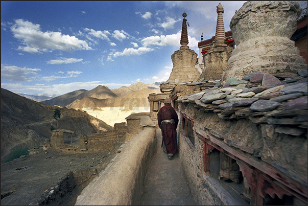 Lamayuru Monastery. A pilgrim in prayer along the path around the Sacred Stupa