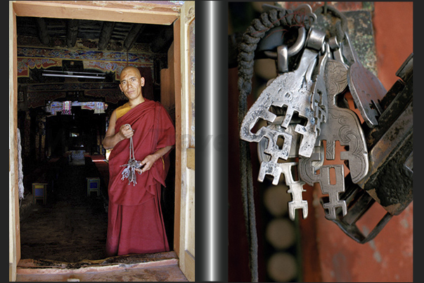 A monk with a bunch of keys in his hand, at the door of a room of the monastery