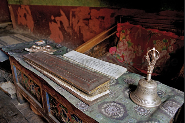 Lamayuru Monastery. Sacred Texts of Buddhism with a bell on the table to indicate to the monks the time and rhythm of prayer