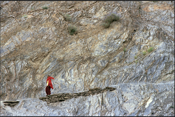 Town of Leh. A young Buddhist monk along the path leading into the town