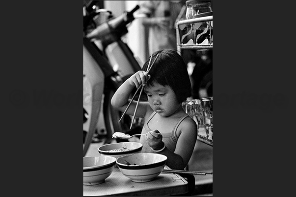 Ho Chi Minh City (Saigon). First steps to learn how to sit at the table to eat