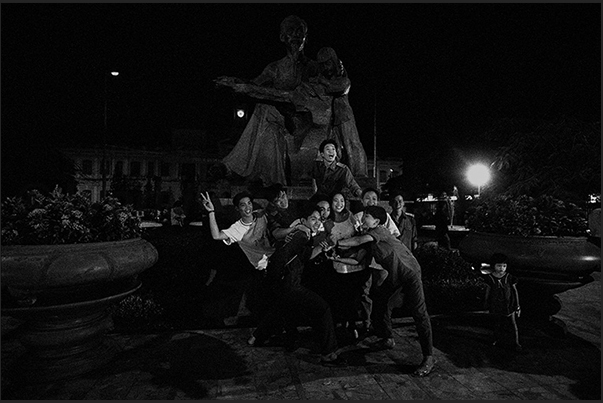 Ho Chi Minh City (Saigon). A group of young people on Saturday night, are having fun under the statue of Ho Chi Ming